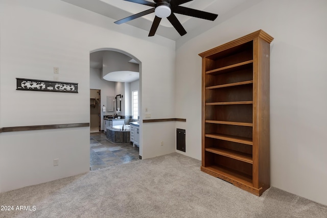 carpeted spare room featuring ceiling fan