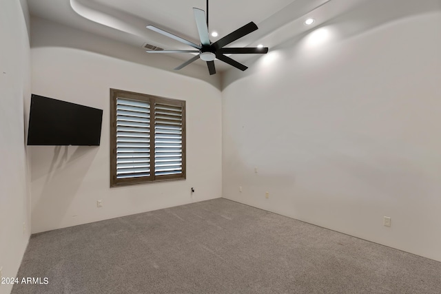 carpeted spare room with ceiling fan