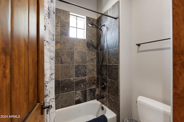 bathroom with shower / bath combo with shower curtain and toilet