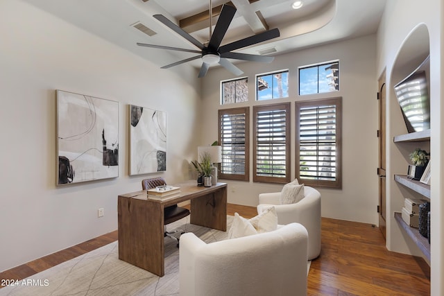 home office with beam ceiling, hardwood / wood-style flooring, ceiling fan, and coffered ceiling