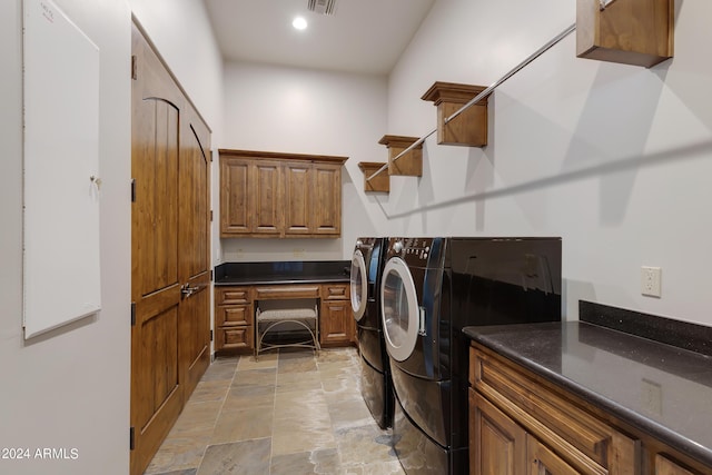 washroom with cabinets and washing machine and dryer