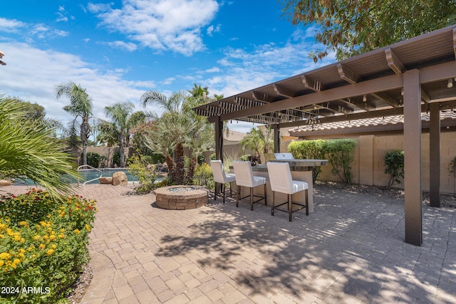 view of patio with a pergola, a swimming pool, and an outdoor bar