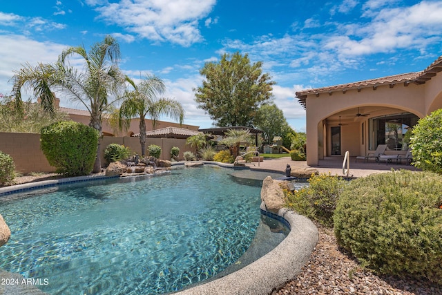 view of swimming pool with ceiling fan and a patio area