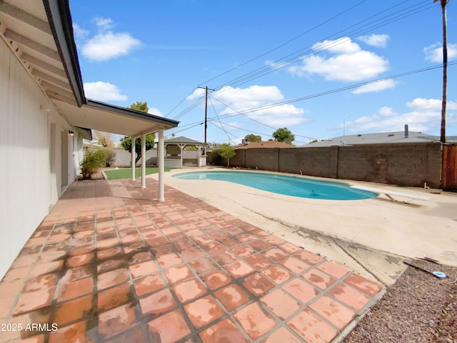 view of swimming pool with a fenced in pool, a fenced backyard, a diving board, a gazebo, and a patio area