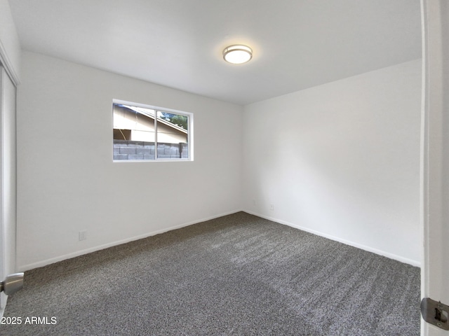 unfurnished room featuring baseboards and carpet floors