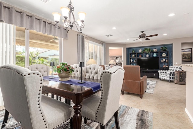 dining room featuring light tile patterned floors, ceiling fan with notable chandelier, visible vents, and plenty of natural light