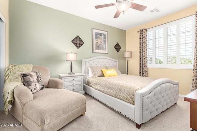 carpeted bedroom with baseboards, visible vents, and ceiling fan