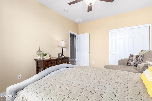 bedroom with a closet, visible vents, a ceiling fan, and vaulted ceiling