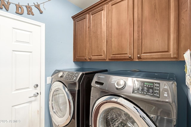 clothes washing area with cabinet space and washing machine and clothes dryer