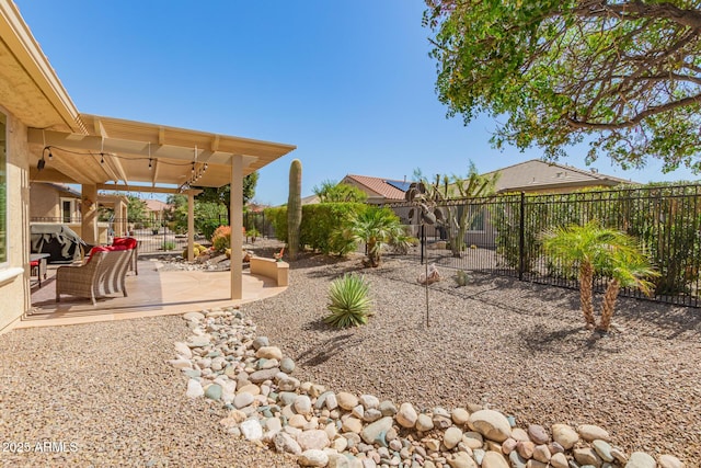 view of yard featuring a patio, a pergola, and a fenced backyard