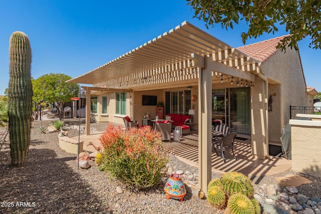 rear view of property featuring a patio, a tiled roof, a pergola, and stucco siding