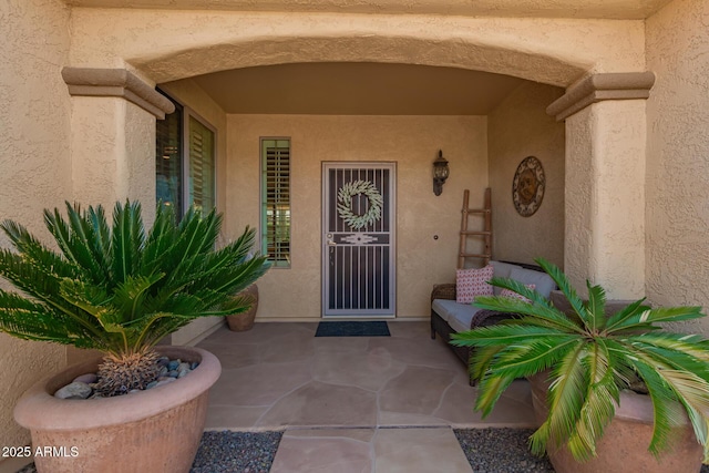 property entrance with stucco siding