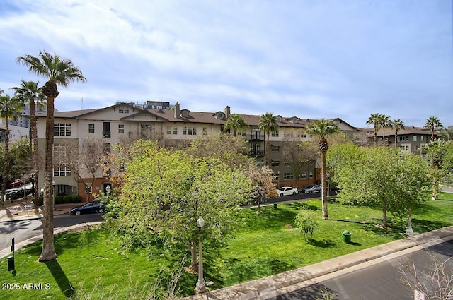 view of property's community featuring a residential view and a yard