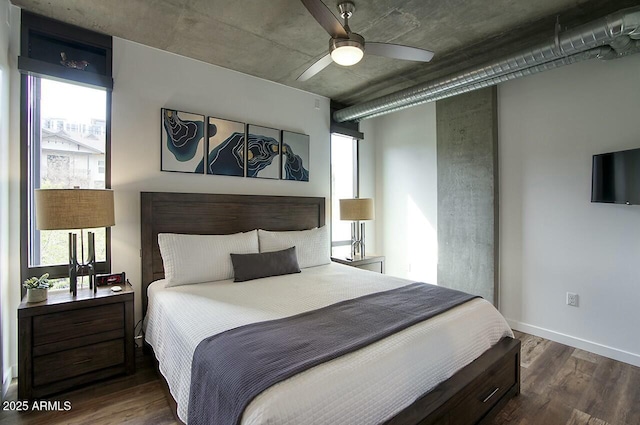 bedroom featuring baseboards, dark wood finished floors, and a ceiling fan