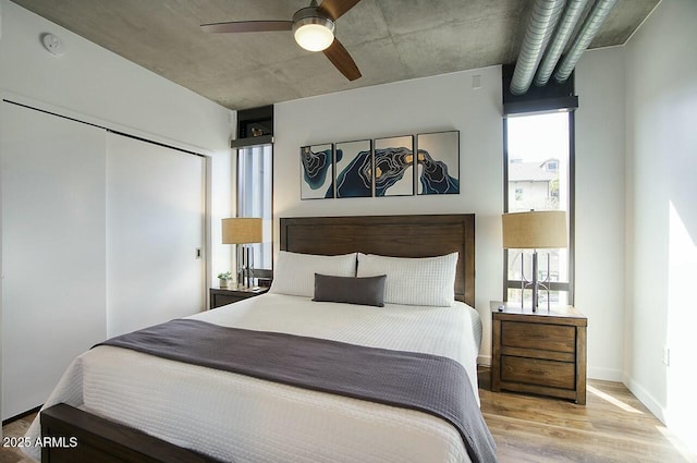 bedroom featuring a closet, a ceiling fan, and light wood-style floors