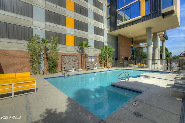 pool featuring a patio area and fence