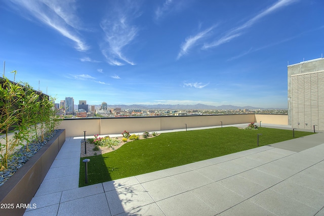 view of yard featuring a view of city and a mountain view