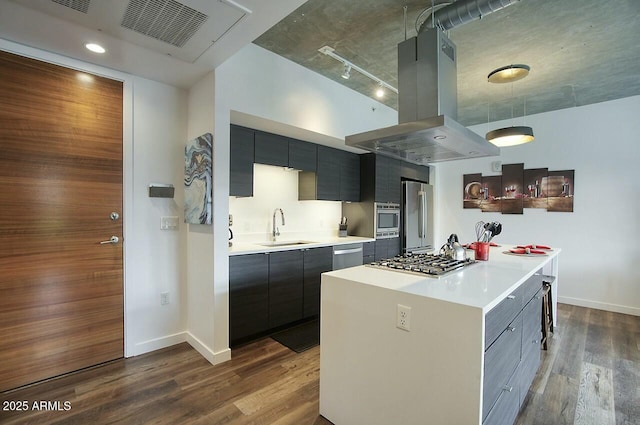 kitchen featuring island range hood, dark wood-style floors, stainless steel appliances, light countertops, and a sink