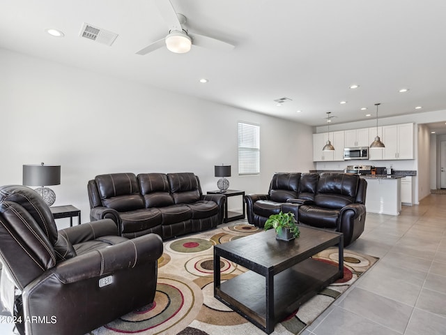 living room featuring ceiling fan and light tile patterned floors