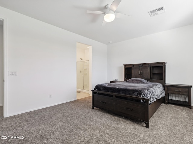 carpeted bedroom with ensuite bathroom and ceiling fan