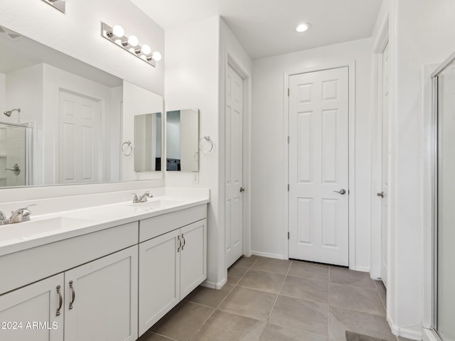 bathroom featuring vanity, an enclosed shower, and tile patterned flooring