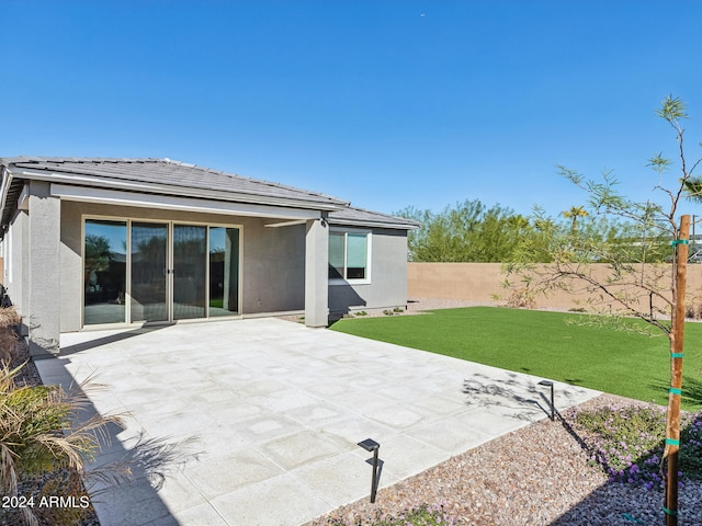 back of house featuring a yard and a patio area