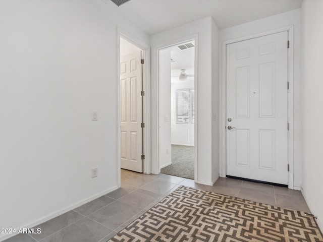 hall with light tile patterned floors