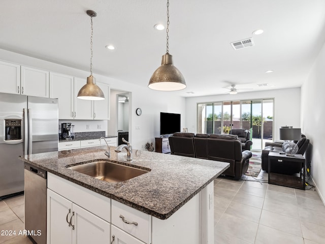 kitchen featuring pendant lighting, a center island with sink, appliances with stainless steel finishes, and sink