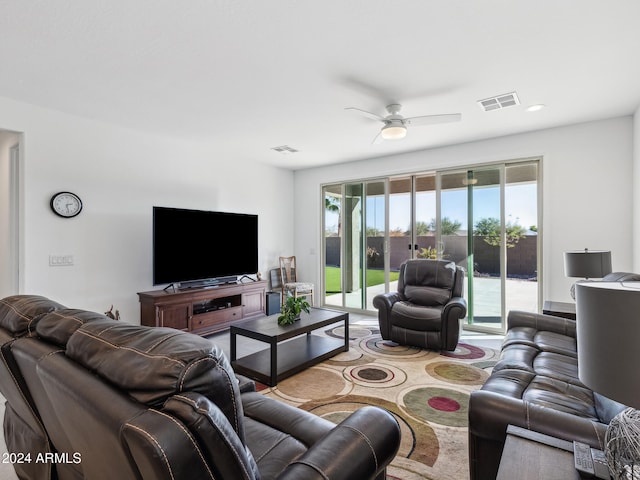 living room featuring carpet floors and ceiling fan