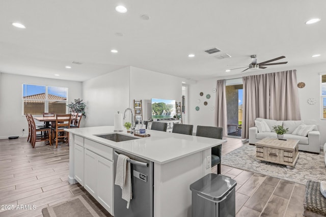 37954 N Greasewood Way, San Tan Valley, AZ 85140 - kitchen featuring dishwasher, wood tiled floors, a sink, open floor plan, and a kitchen island with sink