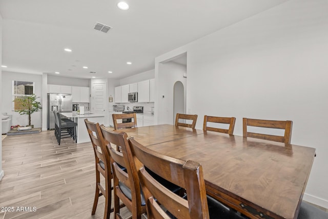 37954 N Greasewood Way, San Tan Valley, AZ 85140 - dining space featuring light wood-type flooring, recessed lighting, baseboards, and arched walkways