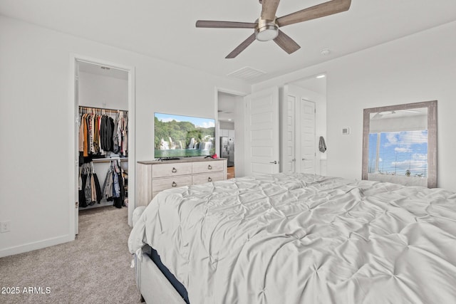37954 N Greasewood Way, San Tan Valley, AZ 85140 - bedroom featuring a spacious closet, light colored carpet, a ceiling fan, a closet, and baseboards