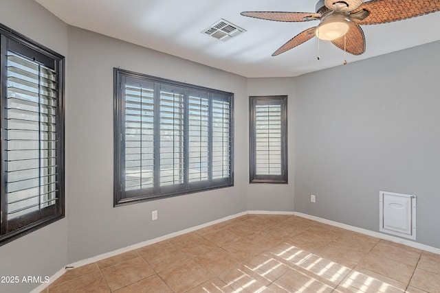 tiled empty room featuring ceiling fan