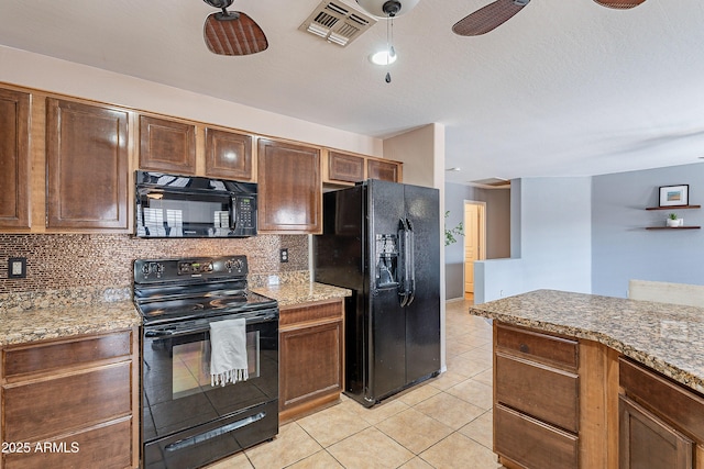 kitchen featuring ceiling fan, stone countertops, decorative backsplash, light tile patterned floors, and black appliances