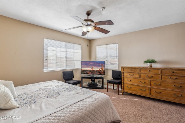 bedroom featuring ceiling fan, carpet flooring, and a textured ceiling