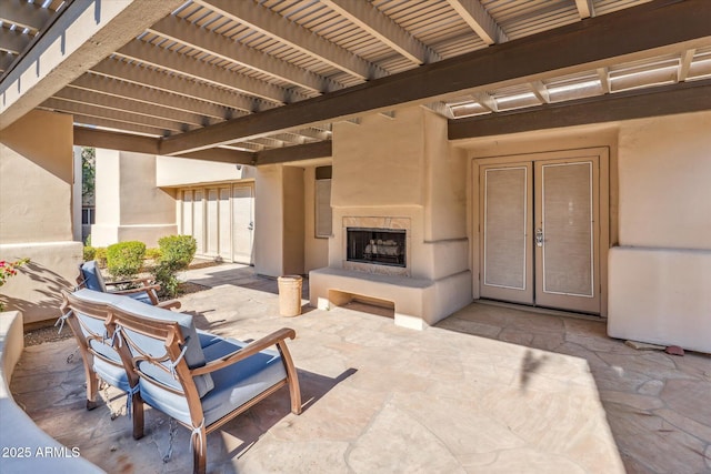 view of patio / terrace with exterior fireplace