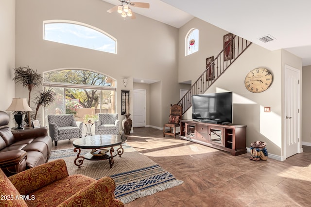 living area with stairway, plenty of natural light, and visible vents