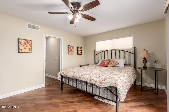 bedroom featuring dark wood-style floors, baseboards, visible vents, and a ceiling fan