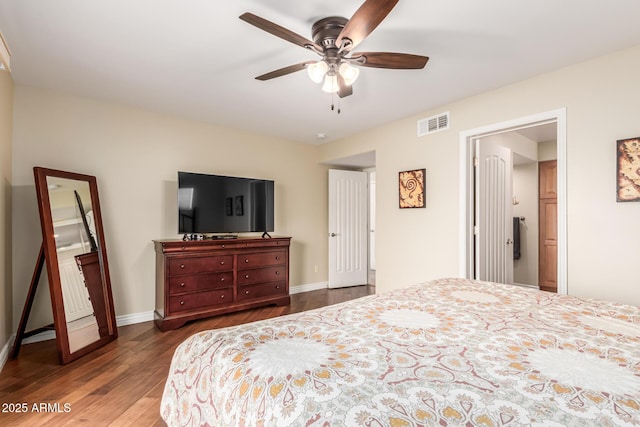 bedroom with dark wood-style floors, visible vents, ceiling fan, and baseboards