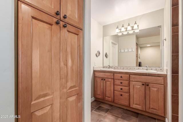 bathroom with tile patterned flooring, a sink, and double vanity