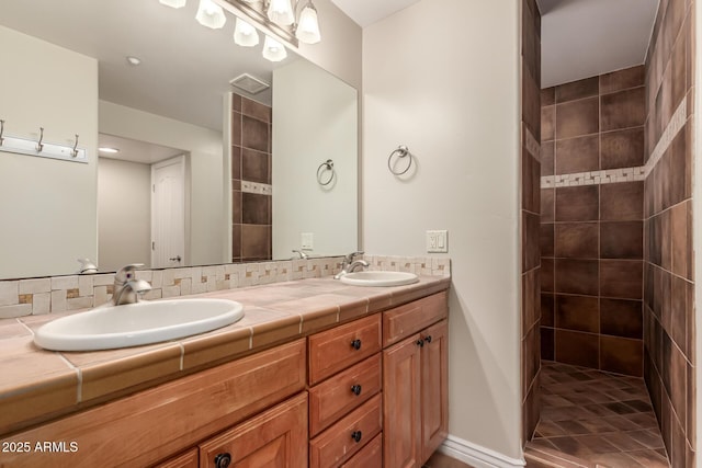 bathroom with a walk in shower, a sink, and double vanity