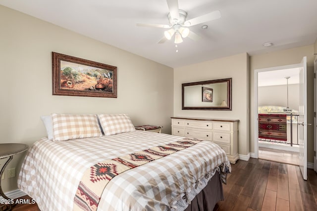 bedroom with dark wood-type flooring, a ceiling fan, and baseboards