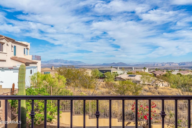 balcony featuring a residential view and a mountain view