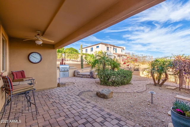 view of patio / terrace with a fenced backyard, a ceiling fan, and area for grilling