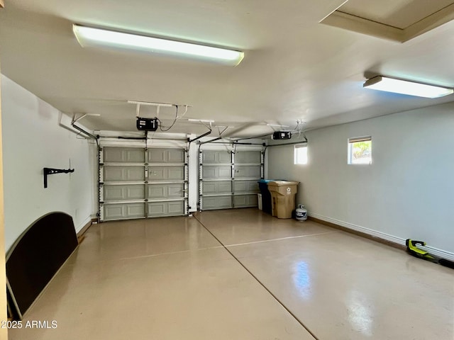 garage with baseboards and a garage door opener