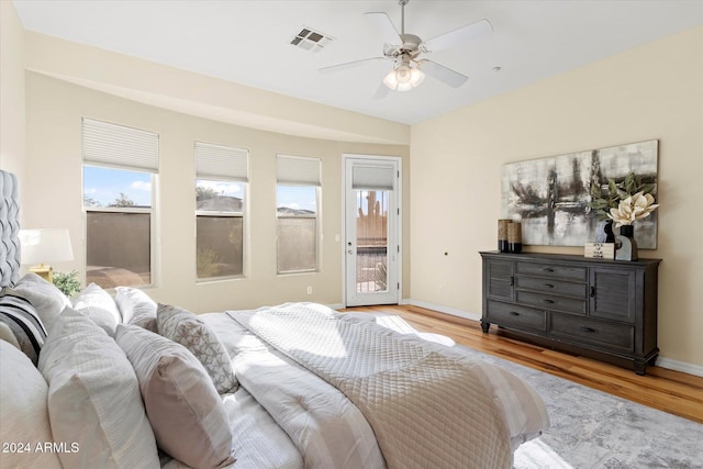 bedroom featuring access to outside, ceiling fan, and light hardwood / wood-style flooring