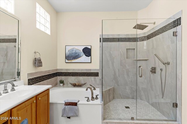 bathroom featuring vanity and shower with separate bathtub