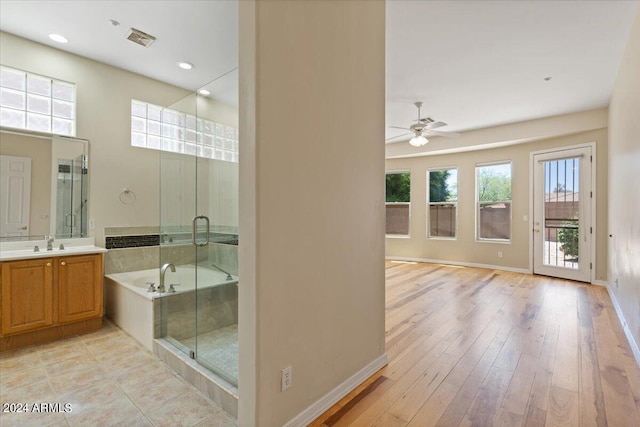 bathroom featuring ceiling fan, hardwood / wood-style floors, vanity, and independent shower and bath