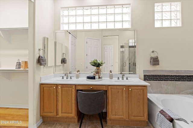 bathroom with shower with separate bathtub, vanity, and plenty of natural light