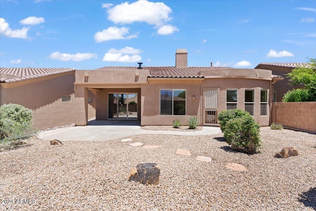 back of house with a patio